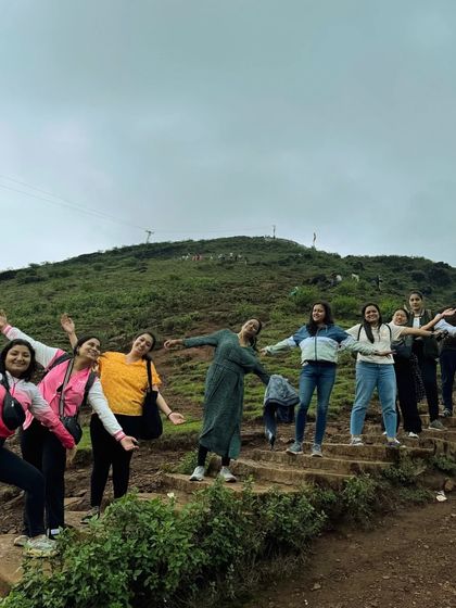 Spreading our arms wide on the steps of a trekking path in Chikmagalur, embracing the freedom of the mountains.