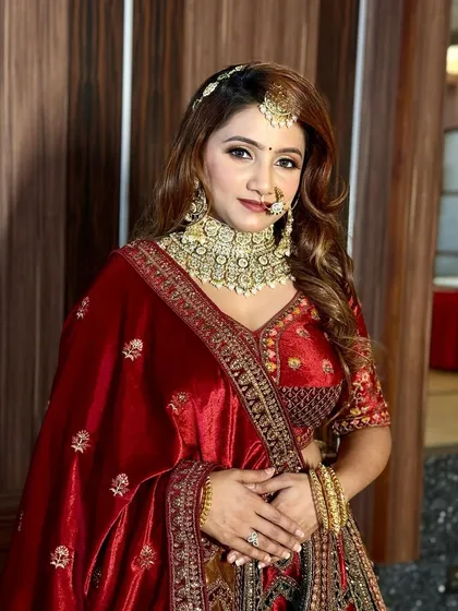 A royal reception look for a queen. This bride is wearing a rich velvet lehenga, and we paired it with a bold, glamorous makeup look featuring defined eyes and flawless skin.