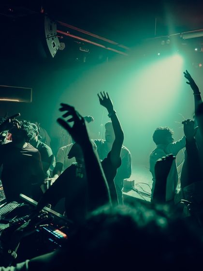 The crowd with their hands up at a Beats & Banter event. When the beat drops, the energy in the room is everything.