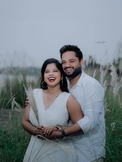Pure, unrestrained laughter is the best. This candid shot captures a moment of genuine joy between the couple, making it a precious memory.