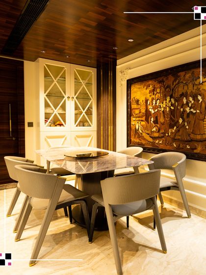 A dining area is where memories are made. This space combines modern chairs with a classic marble-top table and a beautiful piece of traditional art, creating a perfect blend of old and new.