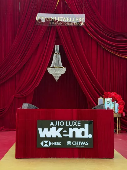 We believe an event's first impression is everything. This grand entrance we designed for the Ajio Luxe WKND event used rich red velvet drapery and a classic chandelier to create a dramatic and luxurious welcome for a high-fashion evening.