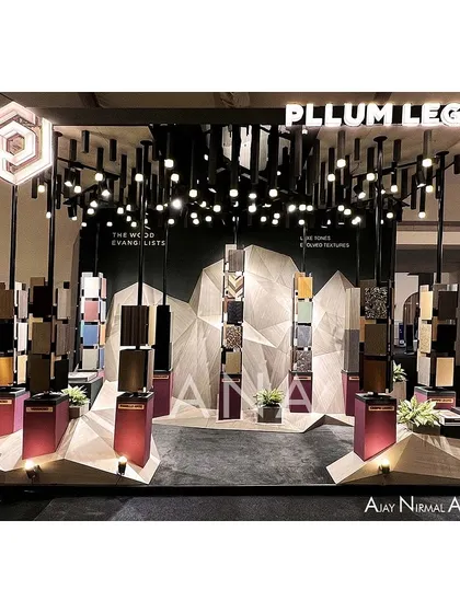 For a compact 15 sq.m space for Pllum Legno, we moved beyond a typical pavilion to create a dynamic art installation. The design uses an abstract backdrop and dramatic lighting to highlight the veneer products as sculptural objects.