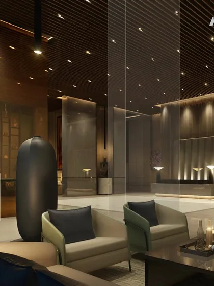 Another view of the One Marina lobby, focusing on the reception area. The clean lines of the desk are contrasted with the rich textures of the wood-paneled ceiling and the polished marble floor.