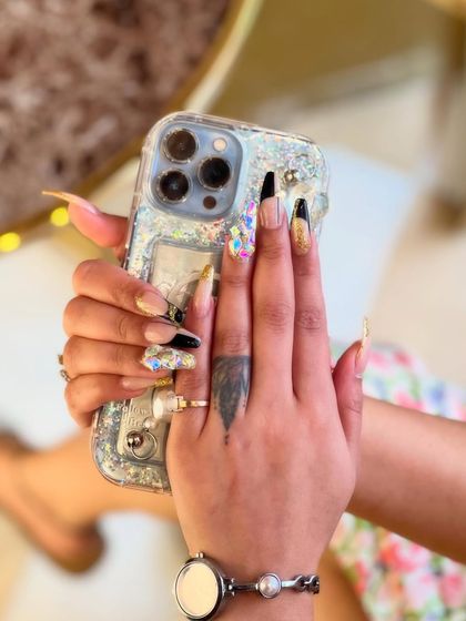 Another perspective of our bold 3D nail art, showing how the different elements, from the sharp black polish to the textured gold and sparkling gems, work together to create a cohesive and high-fashion look.