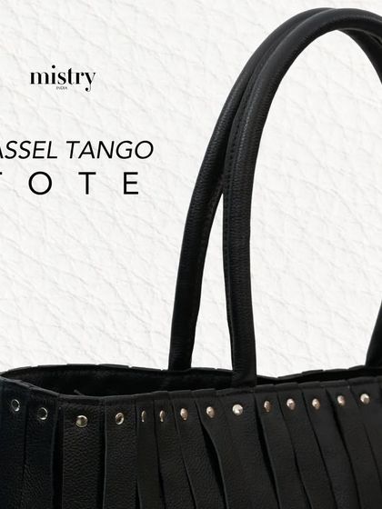 A close-up on the Tassel Tango Tote in black. The antique studs and clean lines show that a touch of tassel is all you need.