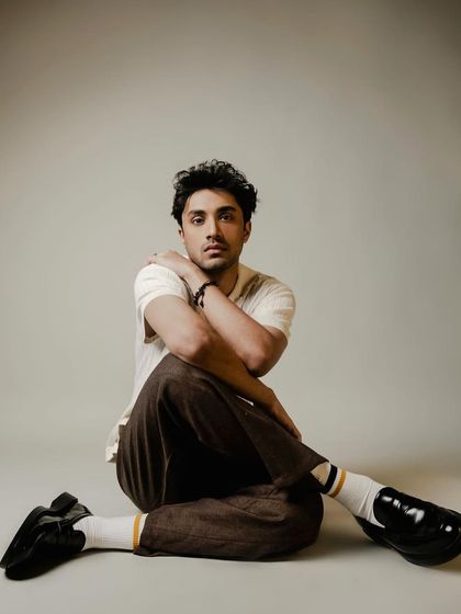 A relaxed and contemporary look for Lakshya Parikh. I styled him in a cream knit polo with brown trousers and loafers for a soft, vintage-inspired aesthetic.