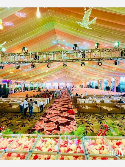 A panoramic view of the 'Bhosale Wedding' hall, showcasing the colorful draped ceiling, lighting truss, and expansive seating layout we designed to accommodate a very large guest list.
