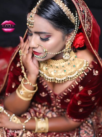 A side profile of the royal bridal look, showing the intricate details of the jewellery, the classic red lip, and the traditional nath (nose ring).