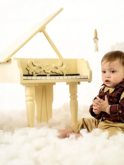A quiet, thoughtful moment by the piano. Not every shot has to be a big smile; these serene portraits are just as precious.