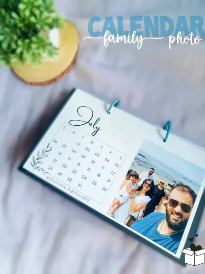 The July page of a family photo calendar, capturing a happy selfie moment. Each month brings a new smile.