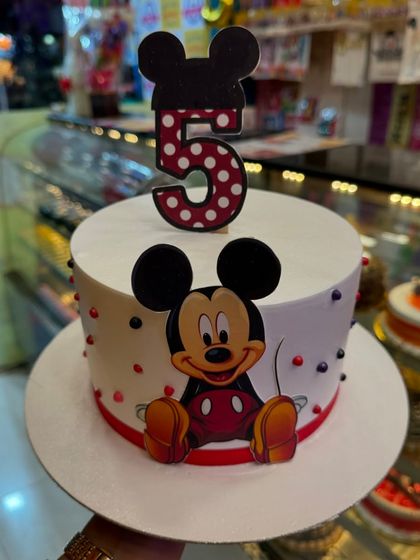 A classic Mickey Mouse cake for a 5th birthday. The design is clean and iconic, featuring Mickey and a bold number '5' topper, perfect for fans of the beloved character.