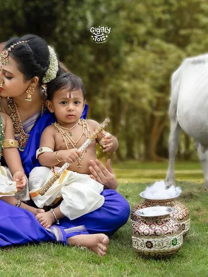 A mother's pure and unending love, captured perfectly as she holds her two little Krishnas close in a serene outdoor setting.