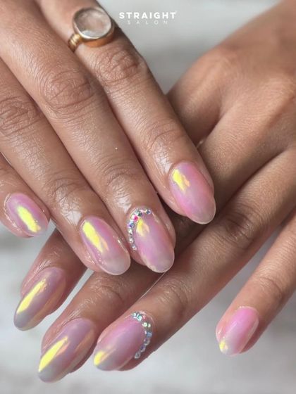 The full two-hand view of the pink chrome nails with rhinestone details. The iridescent glow is simply stunning and perfect for any occasion.
