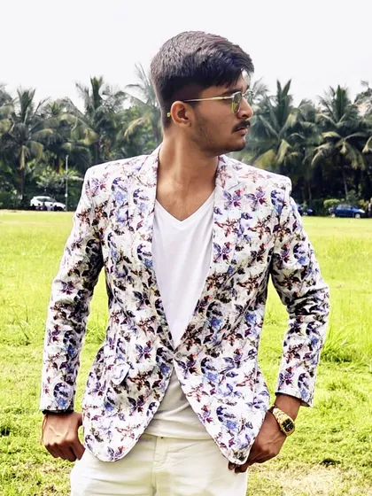 A closer look at the details of our popular floral print blazer. The pattern is modern and stylish, making it a favorite among our younger clients for college events and parties.