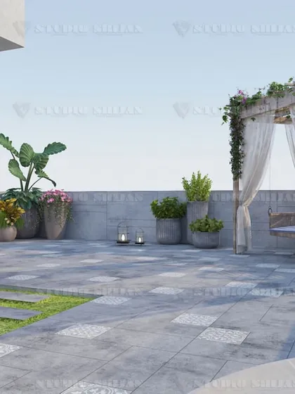 The open area of the terrace, with a mix of stone paving and a small lawn, provides a versatile space for gatherings or simply enjoying the open sky.