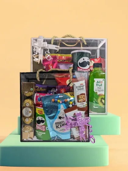 A great gift is one your guests will actually use and enjoy. Our customizable gift hampers are designed for just that. This clear hamper bag is filled with popular treats like Pringles, Ferrero Rocher, and Paper Boat drinks, showing how you can create a fun and memorable thank you gift for any event.