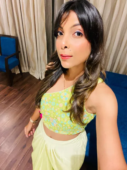 A selfie showing the details of the embroidered one-shoulder top. The fit and fabric of an outfit are so important, and I pay close attention to these details when styling for my clients.