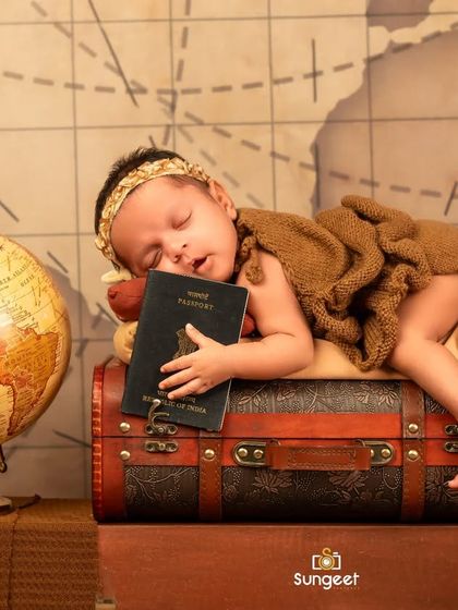 A solo shot of one of the twin travelers, sleeping soundly on a suitcase with her passport. We always make sure to capture both individual and group photos during a twin session.