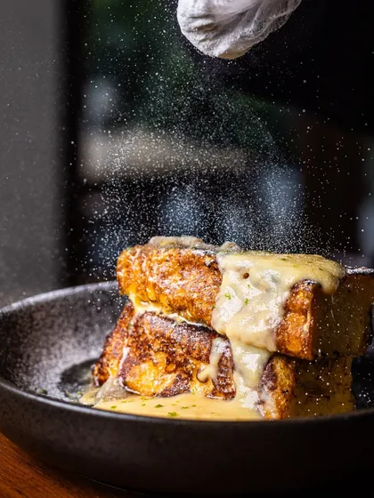 I make my French toast with thick slices of bread, so it’s rich and satisfying. A final dusting of powdered sugar is like a sweet whisper, promising an indulgent start to your day.
