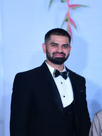 Dressed for a formal corporate gala. I adapt my style to match the tone of your event, whether it requires a sharp tuxedo for a black-tie affair or a more casual look for a relaxed gathering.