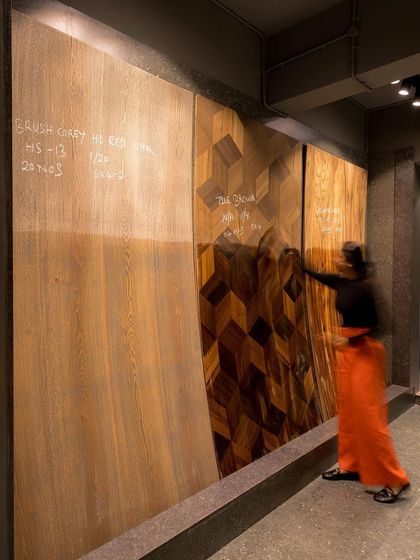 A client interacts with the large-format veneer display, a testament to the showroom's hands-on, experiential design.
