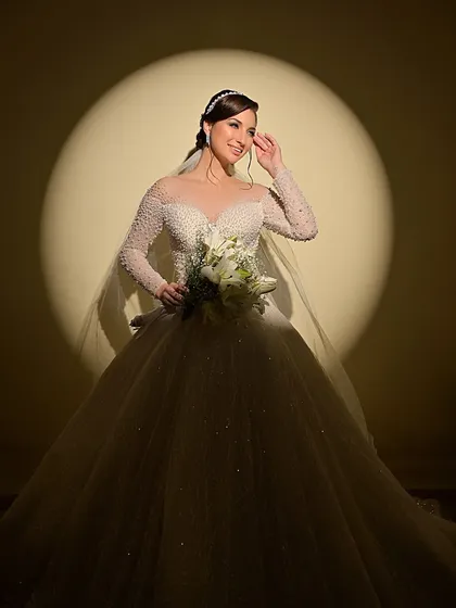 A happy and radiant bride, her smile lighting up the frame. The makeup is designed to look beautiful in both dramatic and natural lighting.