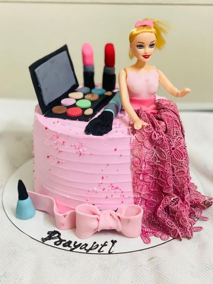 A glamorous Barbie doll cake combined with a makeup theme.