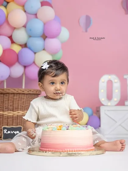 Getting a taste of the good stuff! This little one is enjoying her first-ever cake during her hot air balloon-themed birthday shoot.