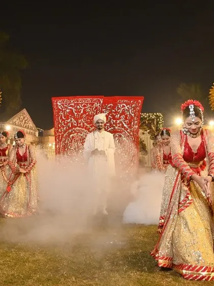 A groom's entrance sets the tone for the celebration. I choreograph powerful arrivals like this one, using dramatic smoke effects and a troupe of synchronized dancers to build excitement and create a grand, memorable welcome.