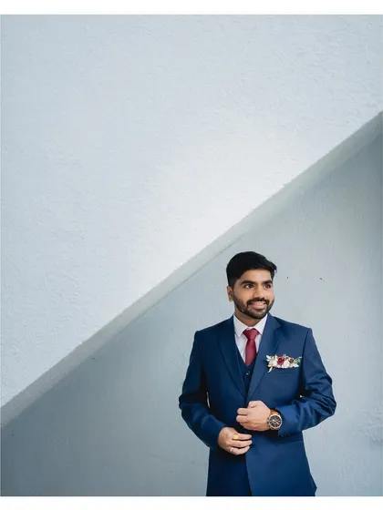 A candid-style portrait that shows the groom looking relaxed and happy. The natural makeup ensures he looks like the best version of himself, not overdone.