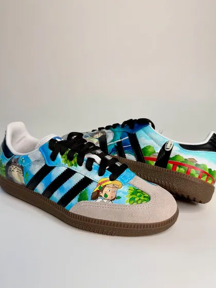 A full view of the Studio Ghibli Sambas. The artwork is spread across both shoes, creating a panoramic scene that captures the whimsical and magical feel of the Ghibli universe.
