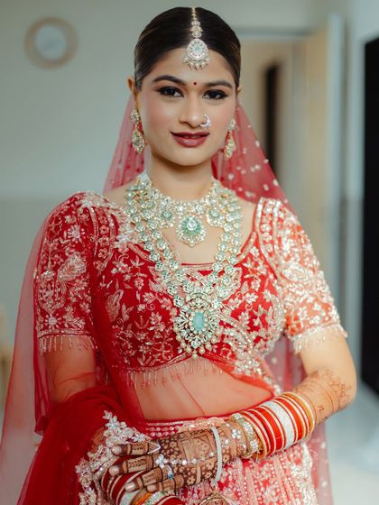 A front-facing portrait showing the symmetry and balance of the makeup. The look is designed to enhance her natural beauty and features.