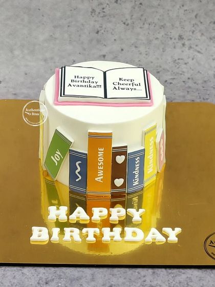 A perfect cake for a bookworm. This design features a stack of books around the base and an open book on top.