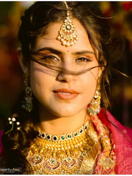 A stunning bridal portrait at golden hour. The wind catches her hair, the light catches her eyes. A moment of pure, confident beauty.