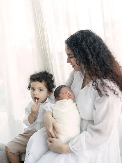The complete family, with a proud big brother and his new baby sibling. These moments are pure gold.