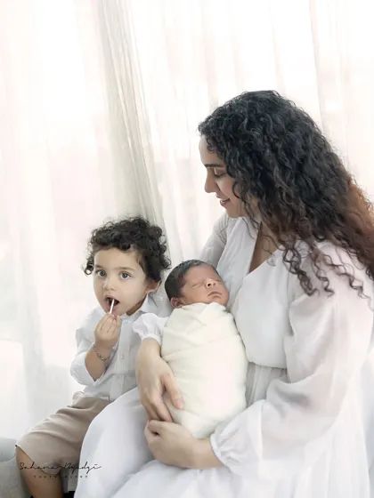 The complete family, with a proud big brother and his new baby sibling. These moments are pure gold.