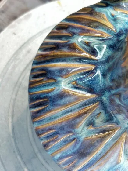 The colors on this pitcher make it one of my favorite pieces. The way the glazes melted and flowed in the kiln created these yummy flashes of blue, purple, and yellow. It’s pure kiln magic.