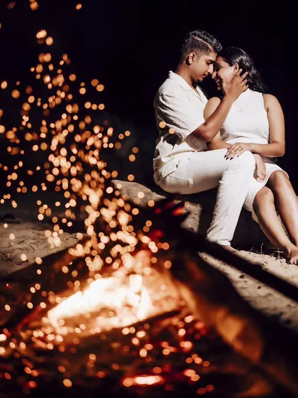 An intimate moment captured with sparks from the fire creating a beautiful bokeh effect. This demonstrates how we can use the environment to create magical photos.