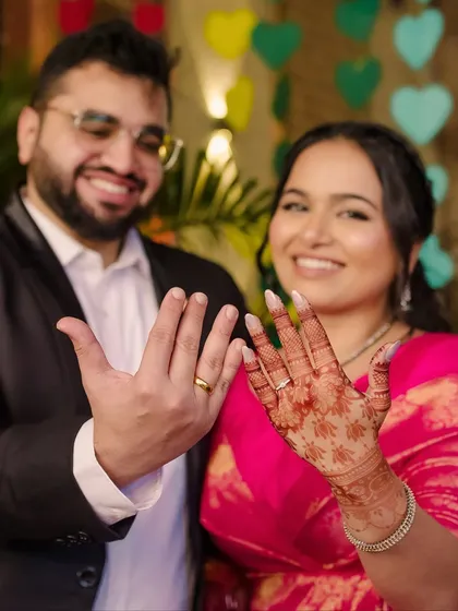 Showing off the rings! A happy, celebratory shot where the bride's radiant makeup and simple hairstyle look effortlessly chic.