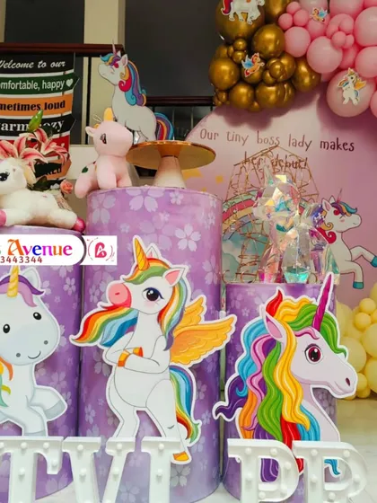 A detailed shot of the unicorn-themed cake stands and character cutouts, adding to the enchanting atmosphere.