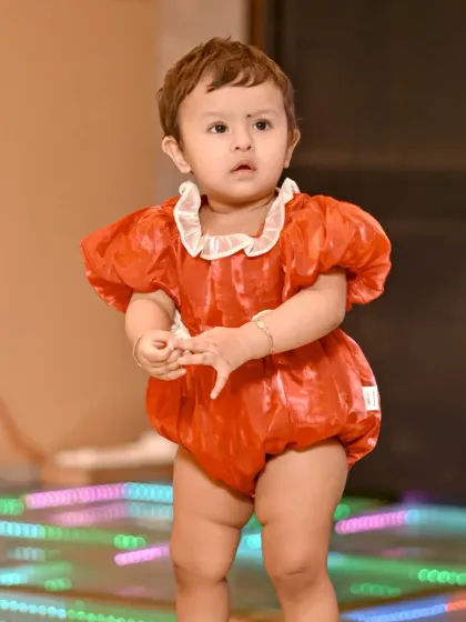 A full shot of the birthday girl in her adorable red outfit. Event photography is all about capturing the energy and different parts of the celebration.