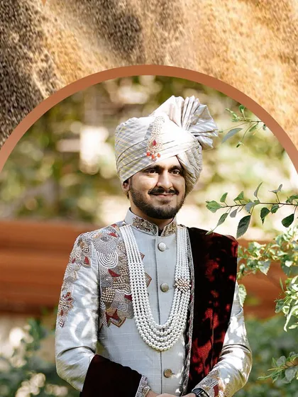 A handsome groom, looking regal in his wedding attire, ready to meet his bride.