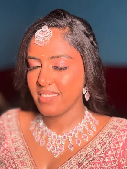 A detailed shot of the reception eye makeup. The shimmering pink shadow and defined lashes make her eyes the star of the show, creating a soft and dreamy effect.