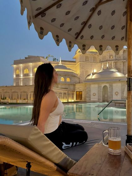 Another perspective of the poolside relaxation at Fairmont Jaipur, emphasizing the serene environment.