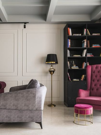 This living room in a Gurgaon residence balances comfort with style. We paired grey and magenta sofas with classic wall paneling and a coffered ceiling to create a space that feels both traditional and refreshingly modern.