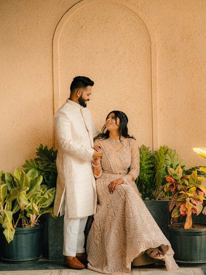 An intimate moment where a couple shares a loving gaze. The warm tones and classic attire make this a timeless and romantic pre-wedding photograph.