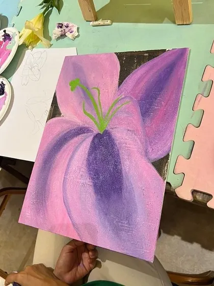 The beautiful result of our abstract floral workshop. This student used bold colors and blended shades of pink and purple to create a stunning, large-scale lily painting inspired by Georgia O'Keeffe.