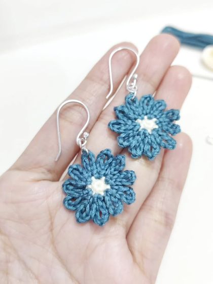 Dainty and elegant micro-crochet flower earrings in a beautiful shade of teal with a cream center.