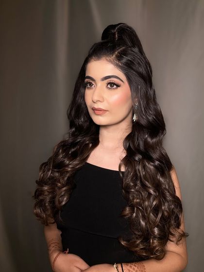 A chic and modern hairstyle for a cocktail party. This high ponytail with soft waves is stylish, keeps hair off the face, and adds a touch of youthful glam.